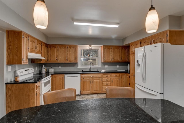 kitchen featuring decorative backsplash, sink, decorative light fixtures, and white appliances