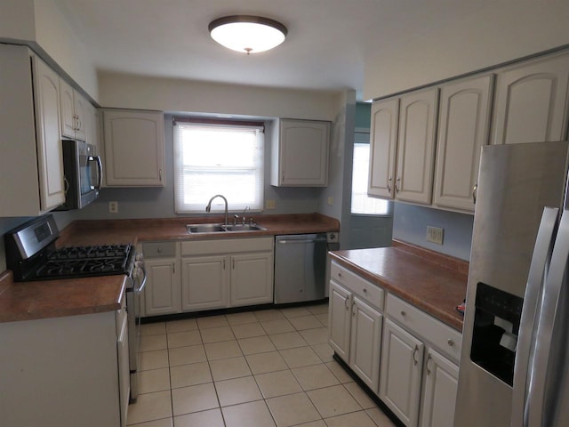 kitchen featuring sink, white cabinets, plenty of natural light, and appliances with stainless steel finishes