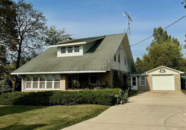 view of front facade with an outdoor structure, a front yard, and a garage