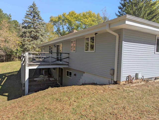 view of home's exterior featuring a lawn and a wooden deck