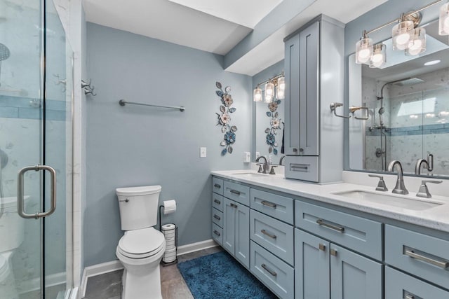 bathroom featuring vanity, toilet, and an enclosed shower