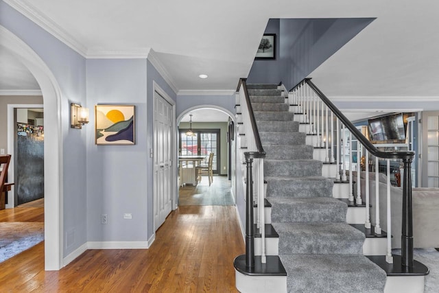 entrance foyer with hardwood / wood-style flooring and crown molding