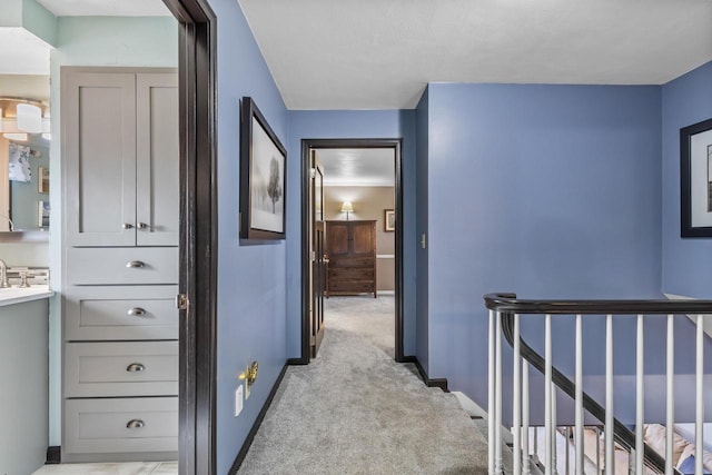 hallway with light colored carpet