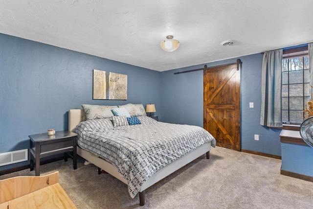 bedroom featuring carpet flooring and a barn door