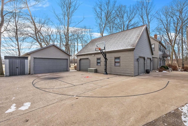 exterior space with a garage and an outbuilding