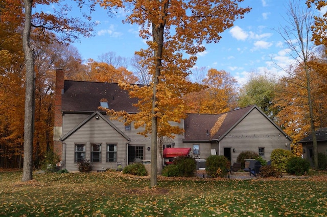 back of property featuring a yard