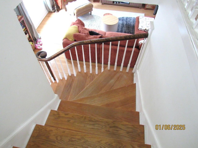 stairs with hardwood / wood-style flooring