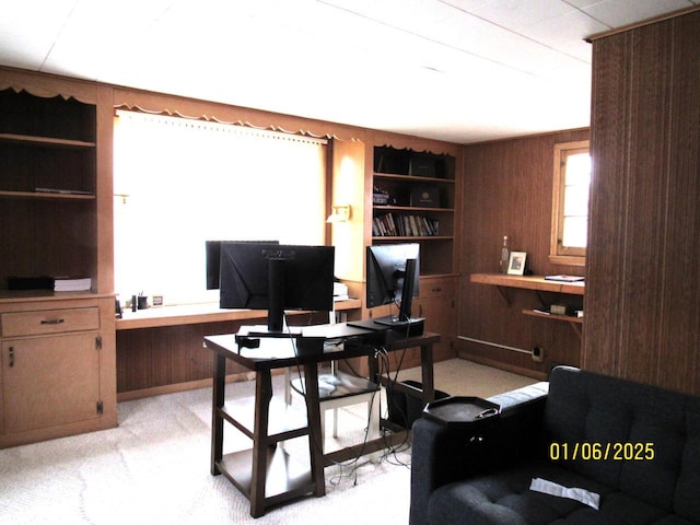 office with built in shelves and wood walls