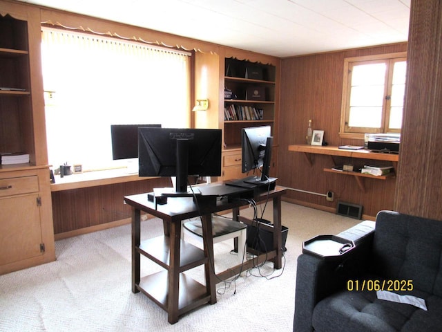 carpeted office space with wooden walls