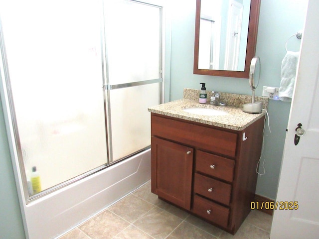 bathroom featuring vanity and bath / shower combo with glass door