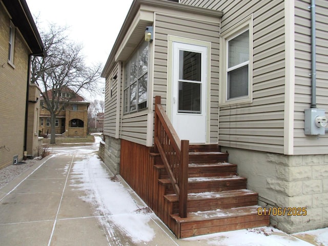 view of snow covered property entrance