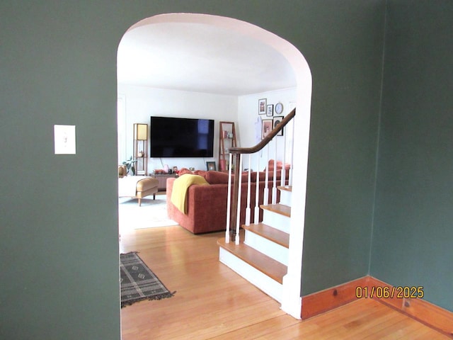 stairs featuring hardwood / wood-style flooring