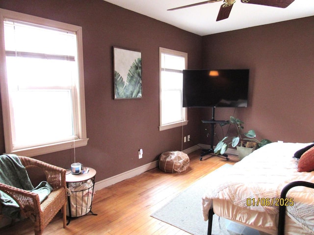 bedroom with ceiling fan and light hardwood / wood-style floors