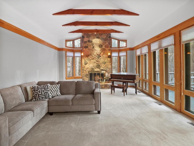 living room with light carpet, beam ceiling, high vaulted ceiling, and a stone fireplace