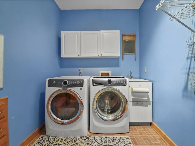 washroom featuring washer and dryer and cabinets