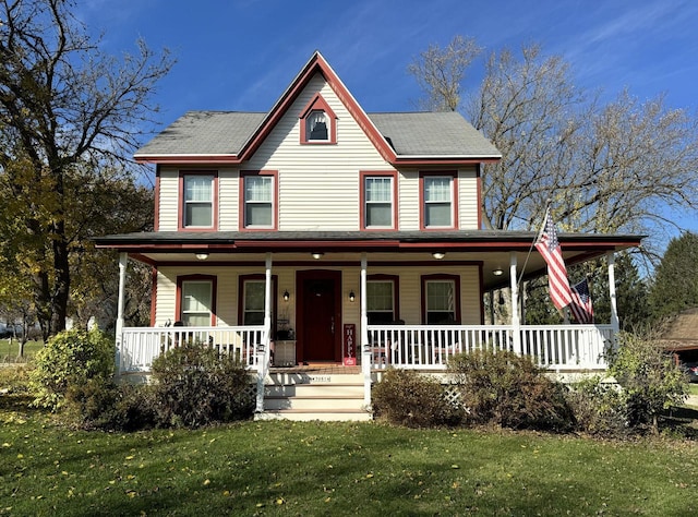 view of front facade with covered porch and a front lawn