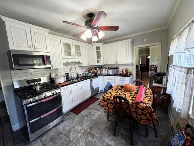 kitchen featuring tasteful backsplash, white cabinetry, sink, and appliances with stainless steel finishes