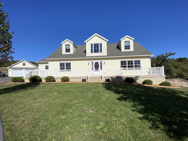 cape cod house featuring covered porch, a garage, and a front yard