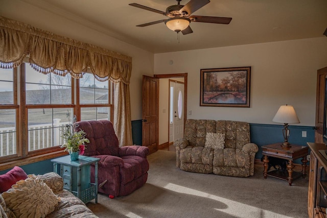 living room featuring carpet and ceiling fan