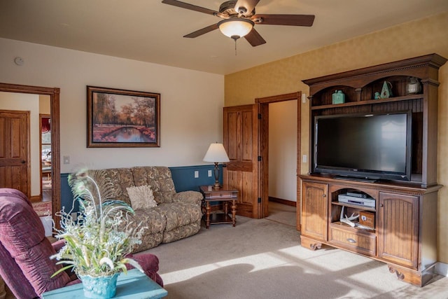 carpeted living room featuring ceiling fan