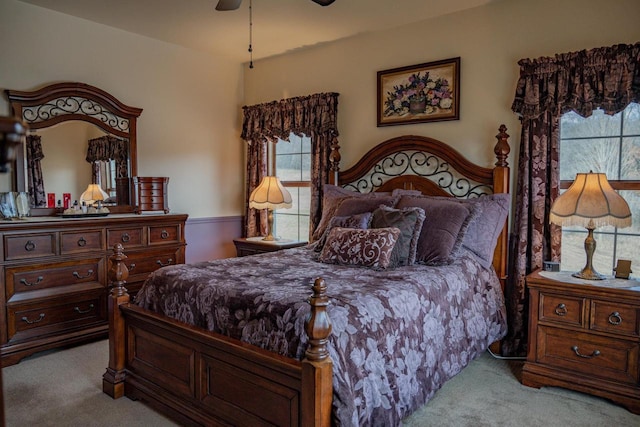 bedroom with ceiling fan and light carpet