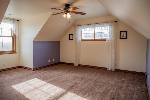 additional living space with ceiling fan, carpet floors, and lofted ceiling