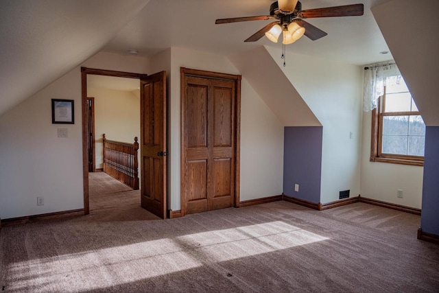 additional living space featuring ceiling fan, carpet, and lofted ceiling