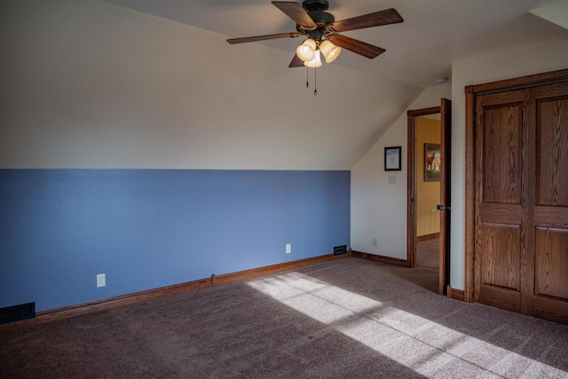 additional living space featuring carpet, ceiling fan, and vaulted ceiling