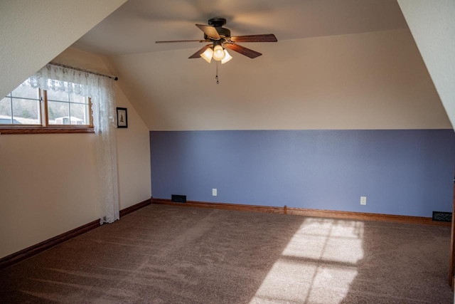 additional living space featuring carpet flooring, vaulted ceiling, and ceiling fan