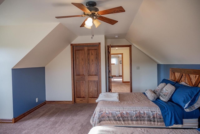 unfurnished bedroom featuring ceiling fan, carpet floors, and vaulted ceiling