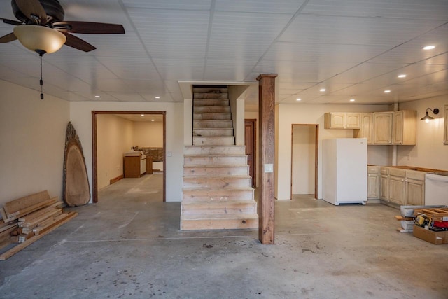 basement featuring ceiling fan and white fridge