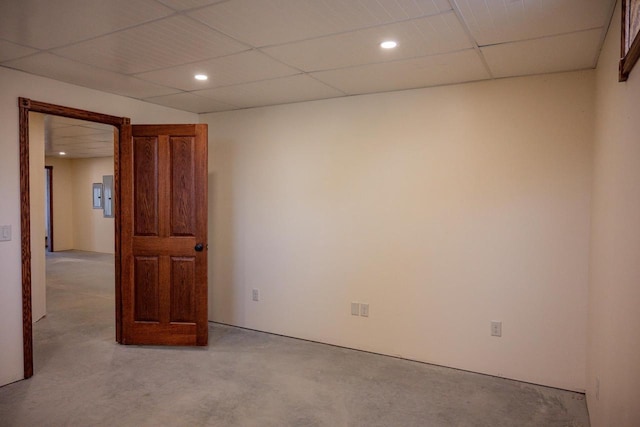 carpeted empty room with a drop ceiling