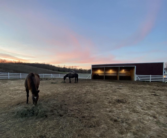 view of horse barn featuring a rural view