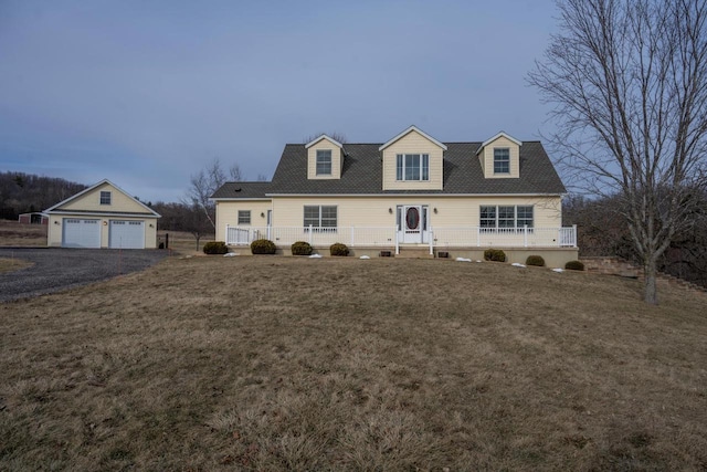 cape cod home with a garage and a front lawn