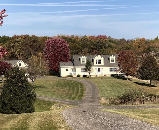 cape cod-style house featuring a front lawn