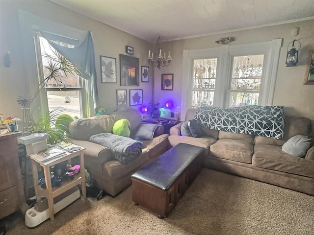 carpeted living room featuring a chandelier and ornamental molding