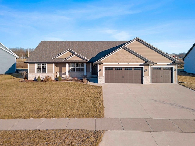 view of front facade featuring a front lawn and a garage