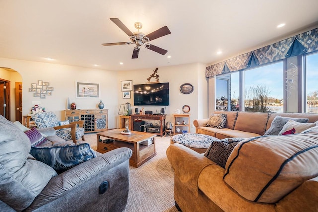 living room featuring carpet flooring and ceiling fan