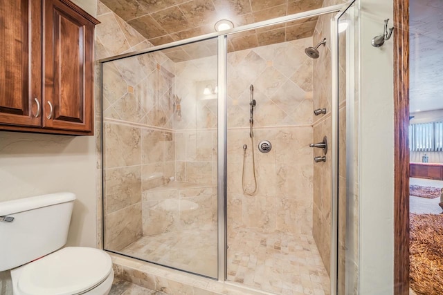 bathroom with a shower with door and toilet