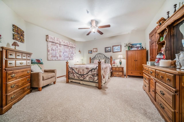 bedroom with ceiling fan and light colored carpet