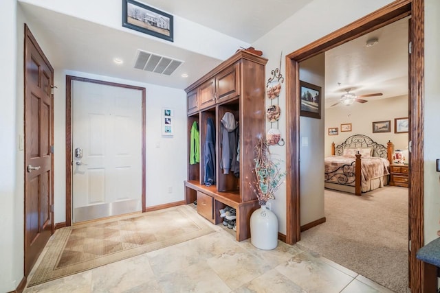 mudroom featuring ceiling fan and light colored carpet