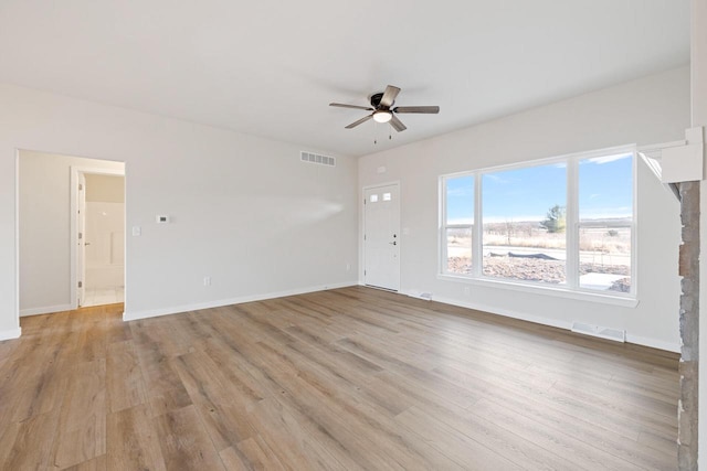 unfurnished living room with ceiling fan and light wood-type flooring