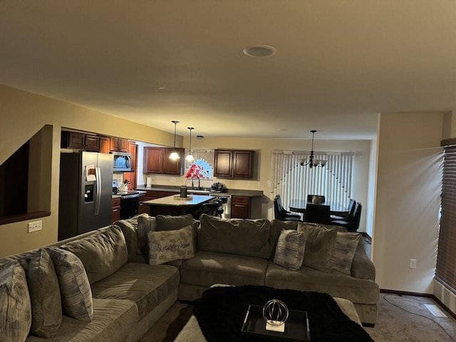 living room featuring a notable chandelier, light colored carpet, and sink