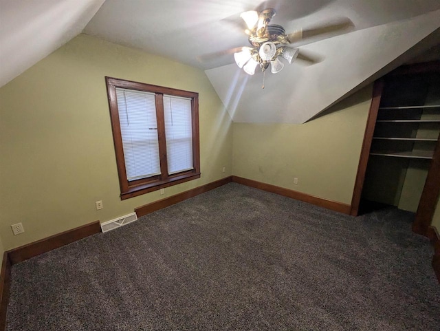 bonus room with ceiling fan, lofted ceiling, and dark colored carpet