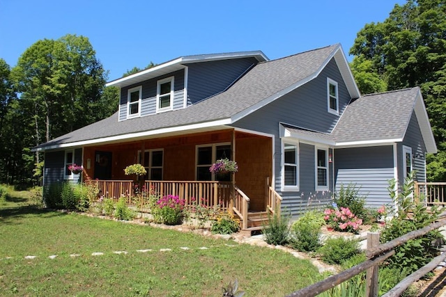 view of front facade featuring covered porch and a front yard