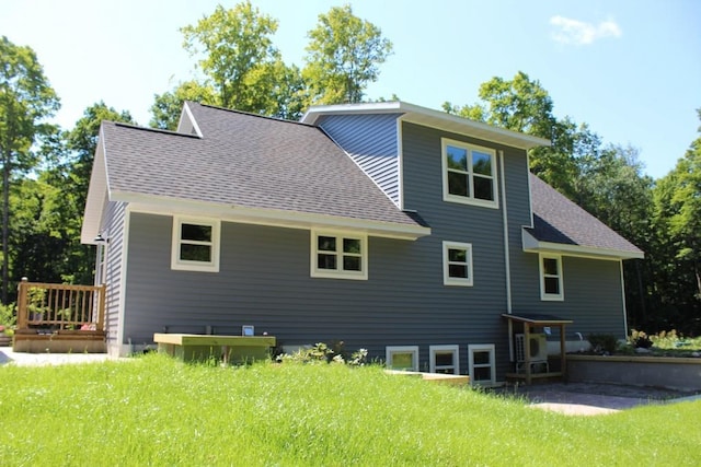 rear view of property with a lawn