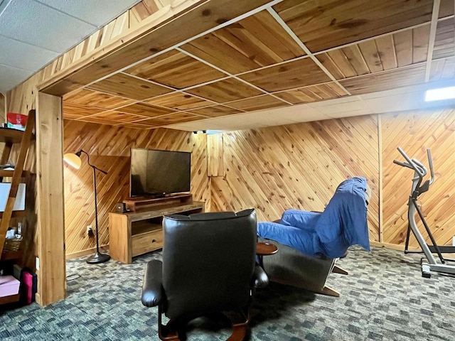 interior space featuring dark carpet, wooden ceiling, and wooden walls