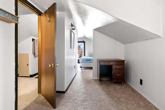 bonus room featuring light carpet and lofted ceiling