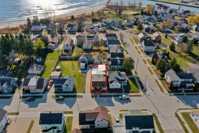 drone / aerial view with a beach view and a water view