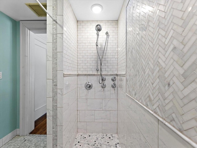 bathroom with tiled shower